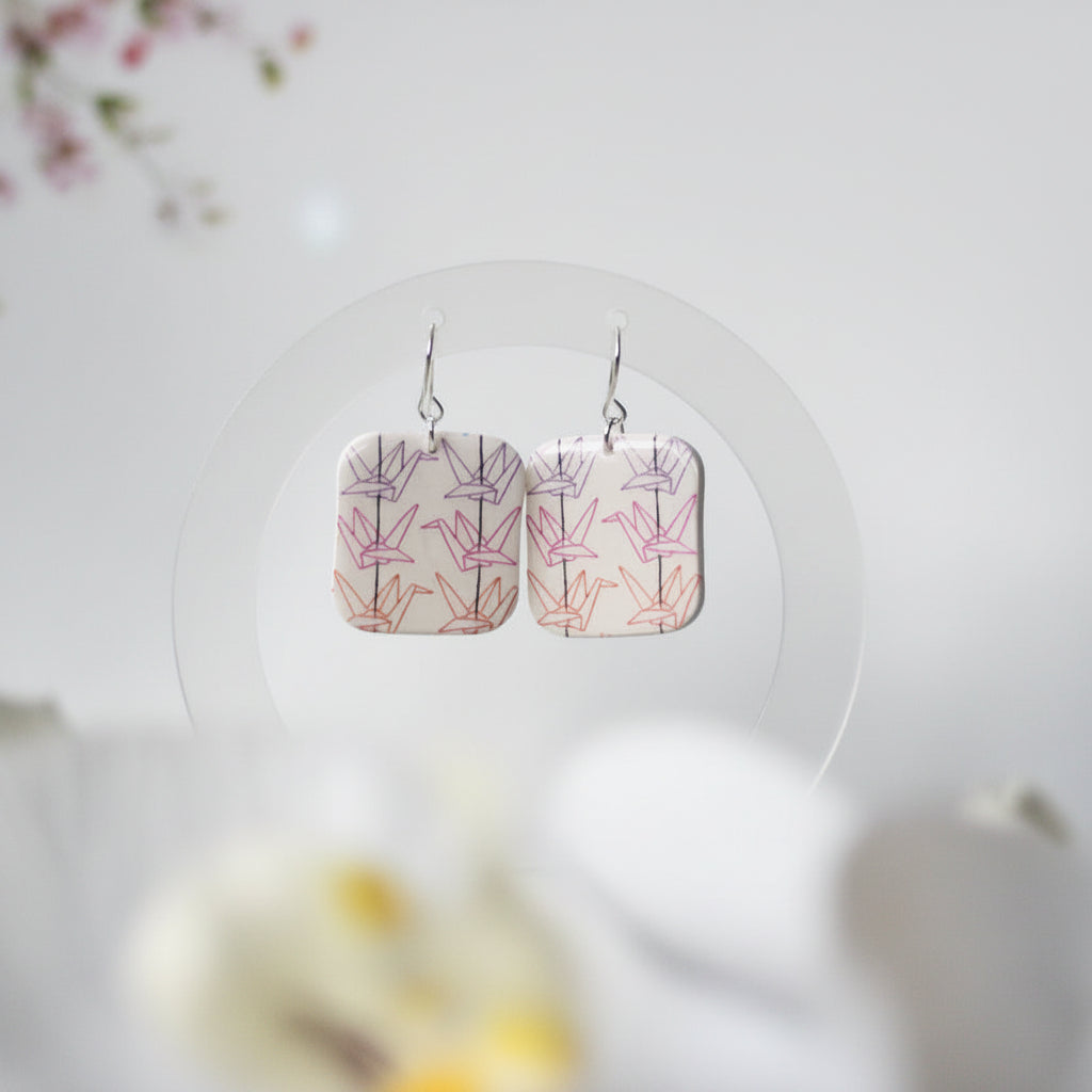 Pair of floral patterned earrings on a white background