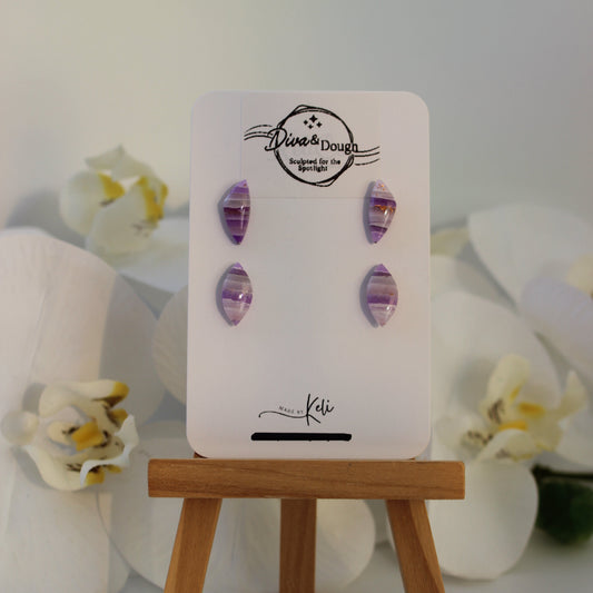 Earring display card with purple earrings on a white background with flowers