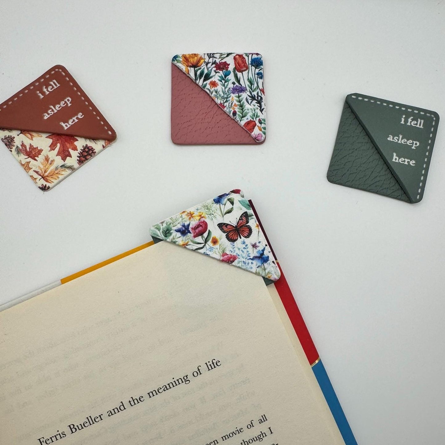 Floral patterned bookmarks on an open book with a white background